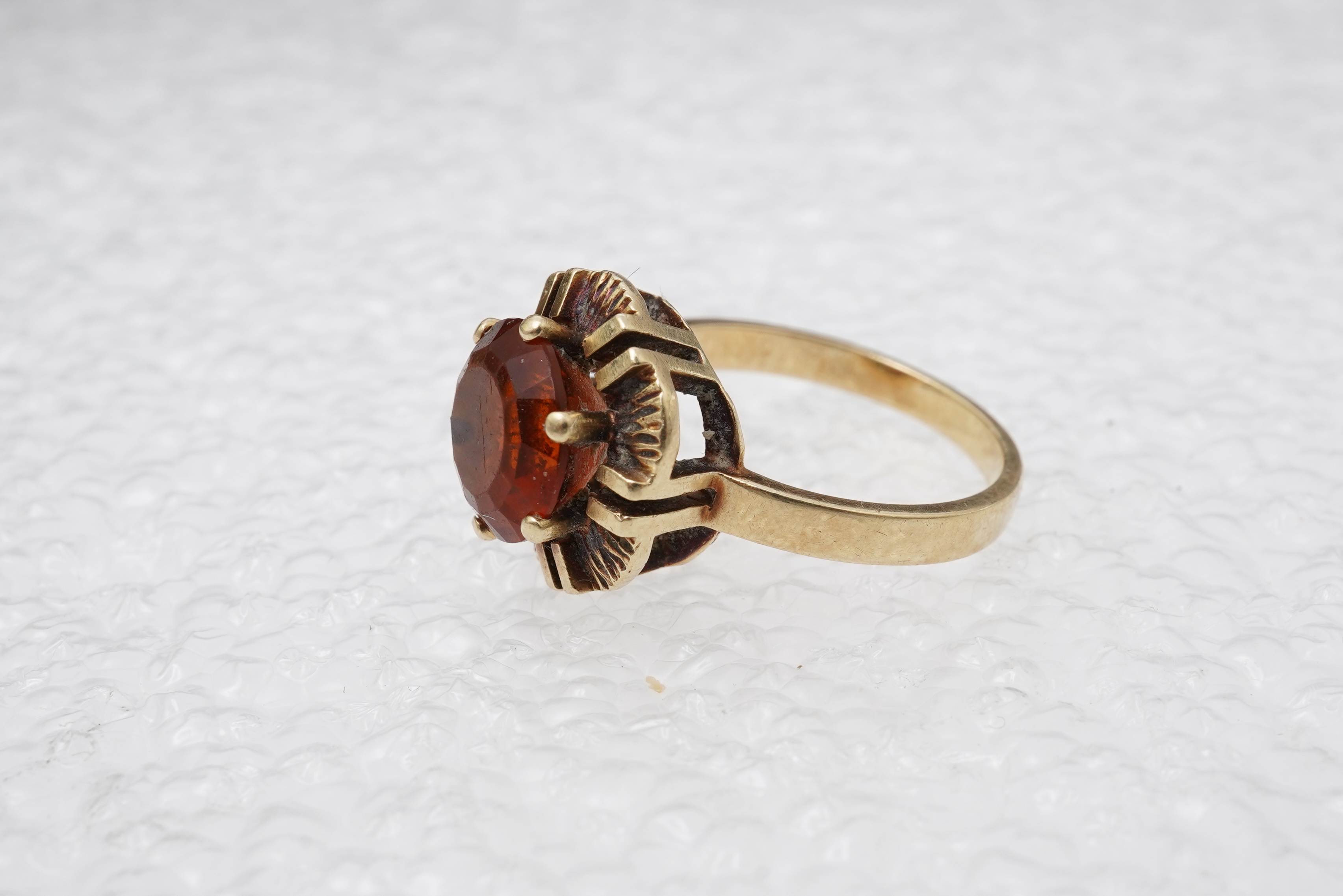 Two brooches and a ring, mid 20th century, comprising: a brooch of floral design, set with circular-cut synthetic gemstones, length 3.7cm, Austrian assay marks for gold, gross weight approximately 6.5 grams; a brooch des